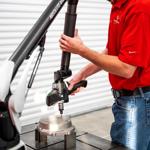 Metrologist Using a Portable Coordinate Measuring Machine (PCMM)