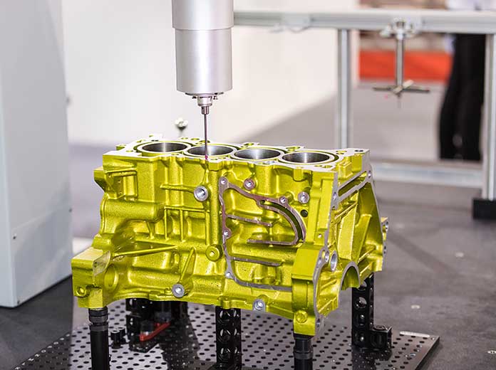 Coordinate measuring machine inspecting a precision engine component to verify dimensional tolerances Coordinate measuring machine inspecting a precision engine component to verify dimensional tolerances